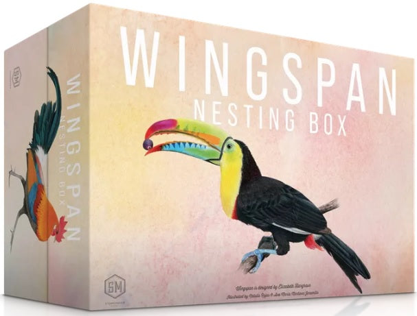 The front of the Nesting Box, the box is a soft yellow and pink gradient. The front features a toucan holding a blueberry in its beak, the side of the box is visible and features a rooster.